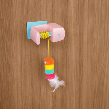 Close-up of Vertical Hunt automatic hanging cat toy featuring feather teaser attachment and bell for interactive cat play