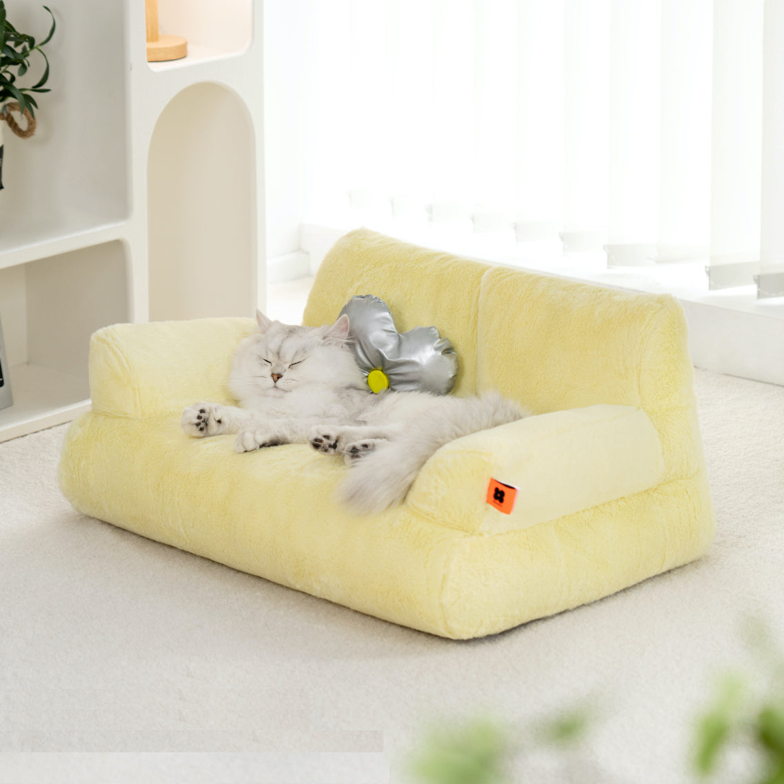 Cat lying on a Mini Yellow Cat Couch