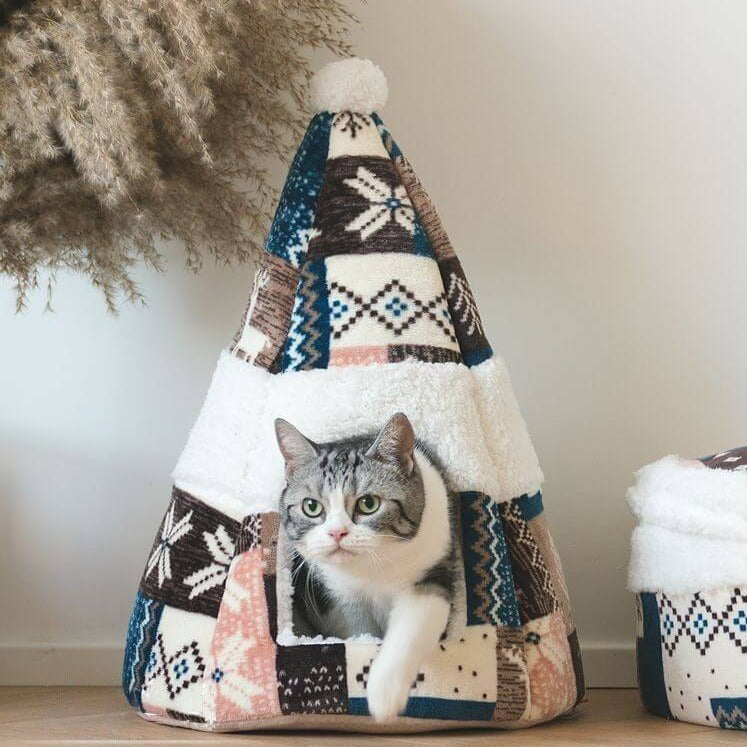 Cat coming out from a Nordic Fair Isle Cat Bed Cave