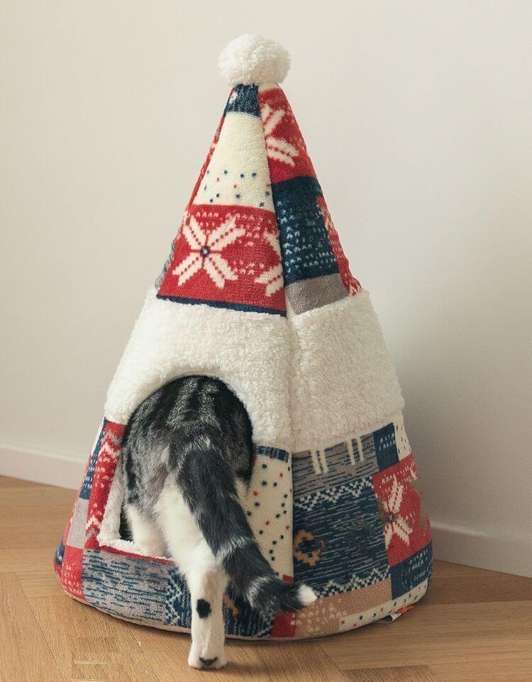A cat coming in a Nordic Fair Isle Cat Bed Cave