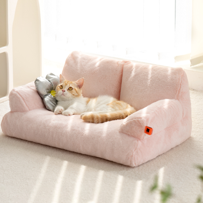 Cat lying on a Mini Pink Cat Couch