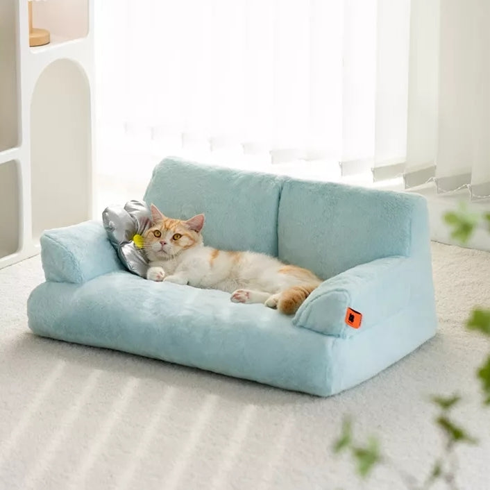 Cat lying on a Mini Blue Cat Couch