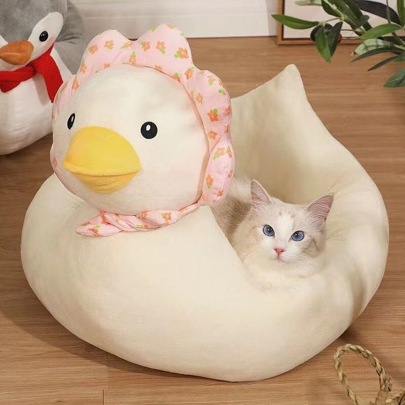 Cat snuggling in a cute duck cat bed